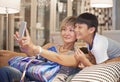 Mother and son posing for selfie on sofa Royalty Free Stock Photo