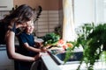 mother and son prepare food in the kitchen healthy food salad vegetables Royalty Free Stock Photo