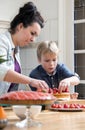 Mother And Son Preparing Cake In Kitchen