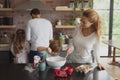 Mother and son preparing cookie on worktop