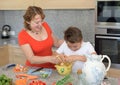 Mother and son preparing lunch using eggs and laugh