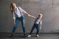 Mother and son pulling hands each other