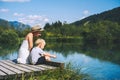 Mother and son relaxing on nature. Zelenci lake, Slovenia, Europe. Royalty Free Stock Photo