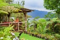 Mother, son relaxing on veranda with tropical garden view Royalty Free Stock Photo