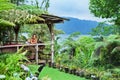 Mother, son relaxing on veranda with tropical garden view Royalty Free Stock Photo