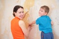 Mother with son remove old wallpapers