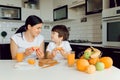 Mother and son sit in the kitchen and eat their hands. Fruit benefits concept. Healthy Eating Royalty Free Stock Photo