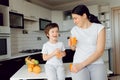 Mother and son sit in the kitchen and eat their hands. Fruit benefits concept. Healthy Eating Royalty Free Stock Photo