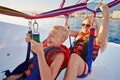 Mother and son sit in motorboat and ready to paraglide Royalty Free Stock Photo