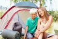 Mother and son sitting in front of tent. Portrait of mother and son sitting in front of tent and giving you an