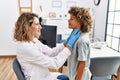 Mother and son smiling confident examining thoat at clinic Royalty Free Stock Photo