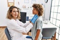 Mother and son smiling confident examining thoat at clinic Royalty Free Stock Photo
