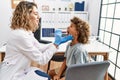 Mother and son smiling confident examining thoat at clinic Royalty Free Stock Photo