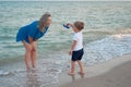 Mother son spending time together sea vacation Young mom child little boy walking beach Royalty Free Stock Photo