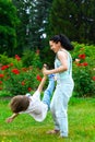 Mother and son spinning in summer park Royalty Free Stock Photo