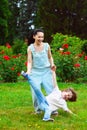 Mother and son spinning in summer park Royalty Free Stock Photo