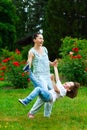 Mother and son spinning in summer park Royalty Free Stock Photo