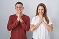 Mother and son standing together over isolated background praying with hands together asking for forgiveness smiling confident Royalty Free Stock Photo