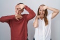 Mother and son standing together over isolated background smiling cheerful playing peek a boo with hands showing face Royalty Free Stock Photo