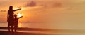 Mother and son at sunset beach, pointing to the Royalty Free Stock Photo