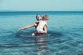 Mother with son swim in water. Happy family on Caribbean sea. Summer vacation and travel to ocean. Maldives or Miami Royalty Free Stock Photo