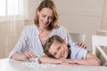 Mother and son at table with domino pieces Royalty Free Stock Photo