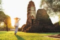 Mother and son tourists walking in atcient Wat Chaiwatthanaram Buddhist temple ruines in holy city Ayutthaya, Thailand in