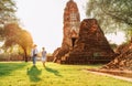 Mother and son tourists walking hand in hand in atcient Wat Chaiwatthanaram Buddhist temple ruines in holy city Ayutthaya, Royalty Free Stock Photo