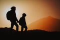 Mother and son travel in mountains at sunset, family hiking Royalty Free Stock Photo