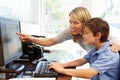 Mother and son using computer at home