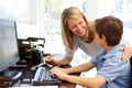 Mother and son using computer at home