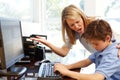 Mother and son using computer at home