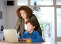 Mother and son using computer at home