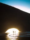 Mother and son walk along the beach