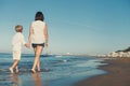 Mother with son walk together on surf sea line Royalty Free Stock Photo