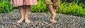 Mother and son Walking On A Textured Cobble Pavement, Reflexology. Pebble stones on the pavement for foot reflexology BANNER long Royalty Free Stock Photo