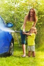 Mother and son washes the car