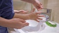 Mother With Son Washing Hands Together