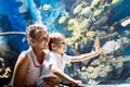 Mother and son watching sea life in oceanarium