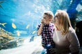 Mother and son watching sea life in oceanarium