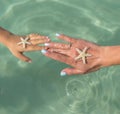 Mother and son watching starfish. Positive human emotions, feelings, joy. Funny cute child making vacations and enjoying summer. Royalty Free Stock Photo