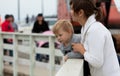 Mother and son watching wildlife from a pier Royalty Free Stock Photo