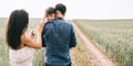 mother and son waving hands on path