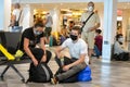 A mother and a son wearing black coronavirus protection masks sit and wait at Pisa Airport, Italy before the second wave Royalty Free Stock Photo