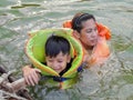 Mother and son wearing a life jacket to swim safely.