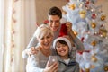 Mother and sons taking selfie at a Christmas party