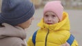 mother soothes a crying little child, mom wipes tears running down her face and hugs a kid with a backpack, educational Royalty Free Stock Photo