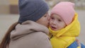 mother soothes a crying little child, mom wipes tears running down her face and hugs a kid with a backpack, educational Royalty Free Stock Photo