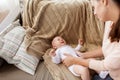 Mother soothing crying little baby boy at home