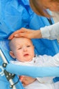 Mother soothing sitting in stroller crying baby